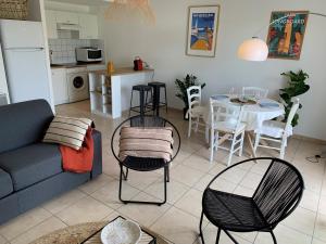 a living room with a couch and a table and chairs at Charmant T2 climatisé à Biscarrosse Plage, à 2 min de la mer, avec balcon et parking inclus - FR-1-319-392 in Biscarrosse-Plage +13 photos