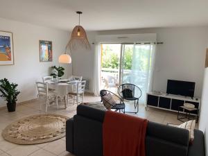 a living room with a couch and a table at Charmant T2 climatisé à Biscarrosse Plage, à 2 min de la mer, avec balcon et parking inclus - FR-1-319-392 in Biscarrosse-Plage
