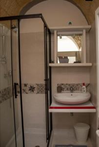 a bathroom with a sink and a shower at La Maison d'Eugenia in Casamassella