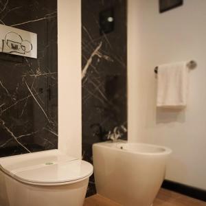 a bathroom with a white toilet and a shower at ArtGallery Apartment - Villa immersa nel verde - Deluxe in Viterbo