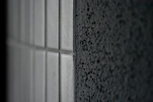 a close up of a tile wall with a window at Kubus in Memmingen