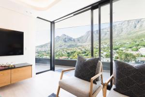 a living room with a view of the mountains at The View - Brand new Penthouse with private rooftop pool in Cape Town