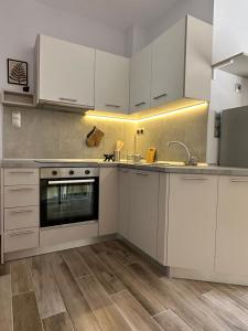 a kitchen with white cabinets and a sink at Giovanni's in Serres