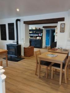 a living room with a table and a stove at le Marronnier in Tramayes