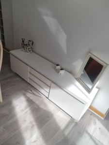 a white bench in a room with a window at 65 Renfield st 2 bed Apartment in Glasgow