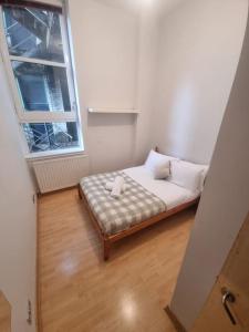 a small bed in a room with a window at 65 Renfield st 2 bed Apartment in Glasgow