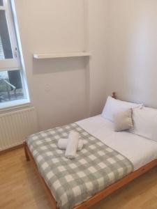 a bed with two pillows on it in a room at 65 Renfield st 2 bed Apartment in Glasgow