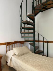 a bedroom with a bed and a spiral staircase at Apart Bosch House in Vicente López
