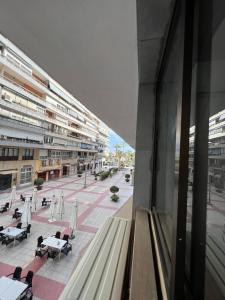 Aussicht aus einem Fenster eines Gebäudes mit Tischen und Stühlen in der Unterkunft pensión La Parada in Alicante
