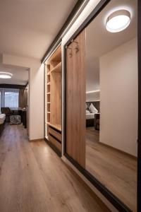 a room with a sliding door leading to a bedroom at Alphotel Garni Salner in Ischgl