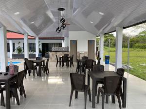 a restaurant with tables and chairs and a patio at Cabañas Villa Albita in Villavicencio
