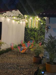a patio with chairs and plants and lights at Cabañas Villa Albita in Villavicencio