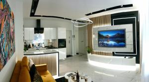 a living room with a large tv on a wall at VIP Room 2+2 in Konin