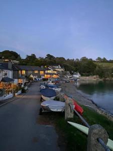 a group of boats parked next to a river at Garden Room @ Bosanath Mill in Falmouth