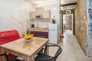 a kitchen with a table with a bowl of fruit on it at Tamaria in Split