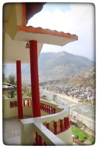 a balcony of a house with a view of the ocean at Kullu Manali Homestay in Kulu