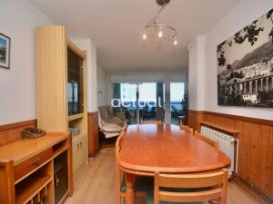 a dining room with a wooden table and chairs at Fanals 5B in Platja d'Aro