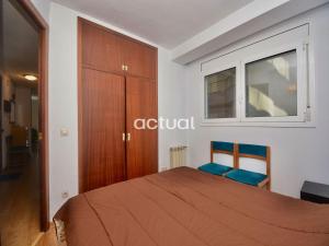 a bedroom with a bed and two blue chairs at Fanals 5B in Platja d'Aro +36 photos