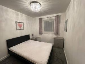 a bedroom with a bed and a window at Moda Wigan 2 - Stylish 2 Bed in Central Wigan in Wigan