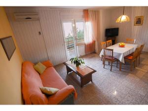 a living room with a couch and a table at Apartment Miranda in Slatine