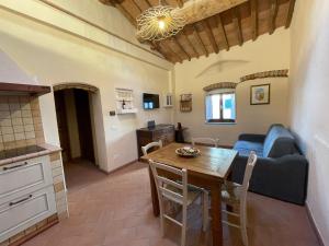 cocina y sala de estar con mesa y sofá en Porta del Chianti Tuscany Apartment, en San Casciano in Val di Pesa