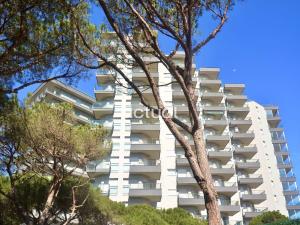 a tall white building with trees in front of it at Fanals 5B in Platja d'Aro