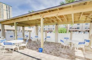 a pavilion with tables and chairs on a patio at Sugar Beach F-26 in Navarre
