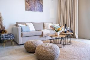 a living room with a couch and two tables at Mythical Spa Suite - GYM*Yoga Room*Pools in Protaras