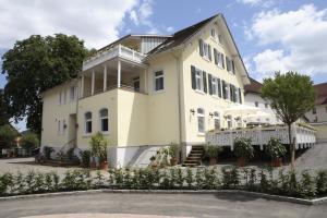 a white house with a lot of plants in front of it at Gasthaus Sternen Post in Oberried