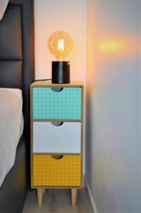 a yellow and blue nightstand with a light on top at Le Central Rhône 2 - vue grandiose - in Lyon