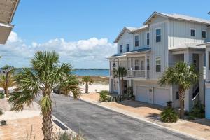 a house on the beach with palm trees at Dream Maker in Navarre