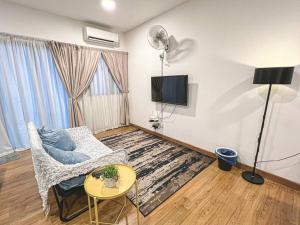a living room with a couch and a tv at Balakong,1-7pax,Cozy Studio,Near Dataran C180 in Cheras
