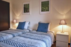 two beds sitting next to each other in a room at Capelas Garden in Capelas