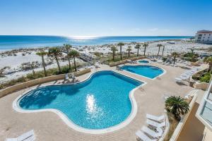 an overhead view of a swimming pool and the beach at Emerald Isle Unit 703 in Pensacola Beach
