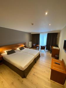 Postel nebo postele na pokoji v ubytování Hotel Melba