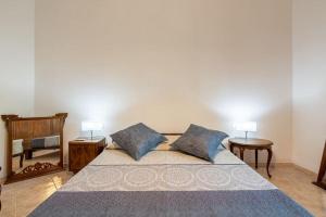 a bedroom with a bed with two pillows and a mirror at La Fortezza in Florence