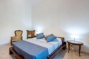 a bedroom with a bed and two chairs and a table at La Fortezza in Florence