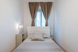 a bedroom with a large bed with a window at La Fortezza in Florence