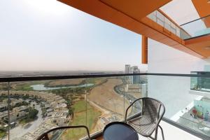 a view from the top of a building with chairs at Key View - Golf Vita in Dubai Marina