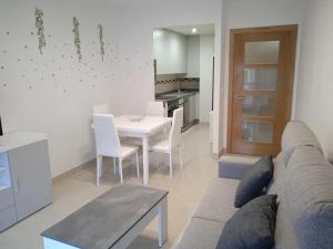 a living room with a couch and a table at Apartamento Mirabel in Rosal