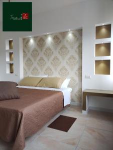 a bedroom with a bed and a wall with a headboard at TWIN HOUSE brown in Tito