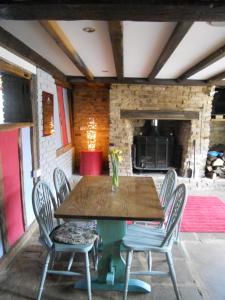 a wooden table and chairs on a patio at The Great Escape - Pet Friendly - Pets stay FREE in Rye
