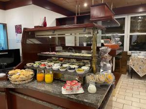 a buffet line with many different types of food at Brunnen Hotel in Essen