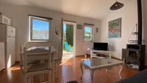 a living room with a table and a refrigerator at Casa Azul Beach and countryside in Armação de Pêra