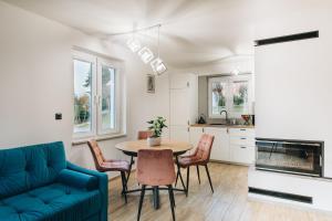 a living room with a table and chairs and a couch at Bieszczadzkie Niebo in Stefkowa