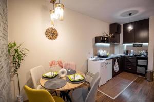 a kitchen and dining room with a table and chairs at Studio Stankovic Royal Towers 326 in Bansko