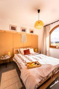 a bedroom with a bed with a tray of fruit on it at Willa Montana - apartament widokowy w Bukowinie Tatrzańskiej in Bukowina Tatrzańska