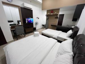 グア・ムサンにあるHASSMA Studio Apartment with Poolのベッド2台とソファが備わるホテルルームです。