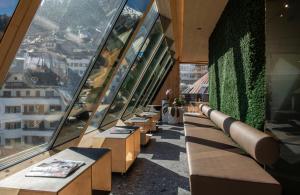 a row of benches in a building with windows at fire & ice LIVING in Ischgl