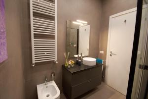 a bathroom with a sink and a toilet and a mirror at Due Strade APT - Dolcevita Holiday in Florence +34 photos